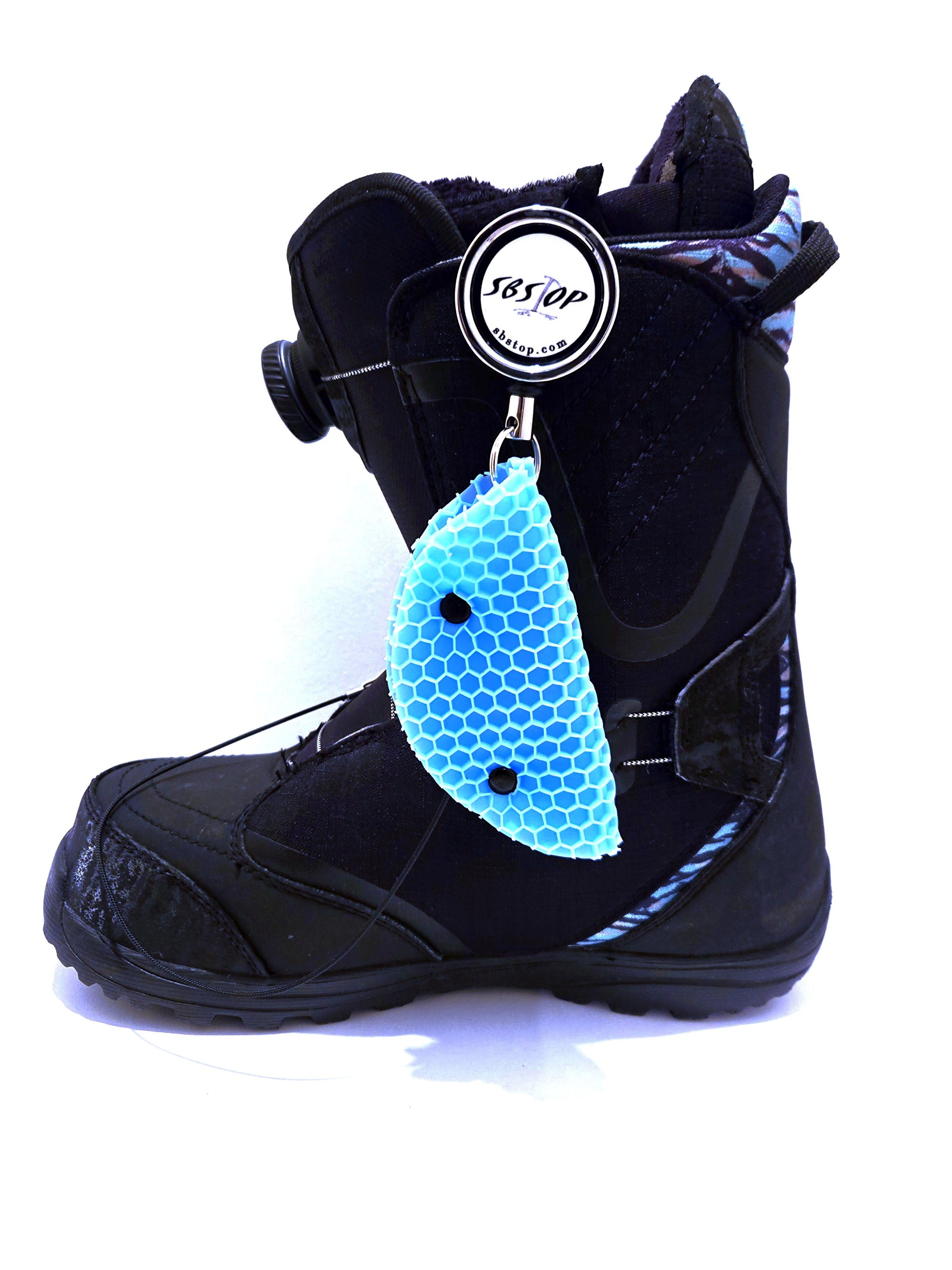 Snowboard rider launching with SBStop Taco Pad installed for stability